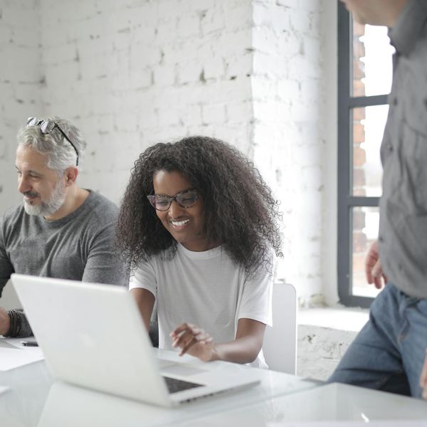 Diverse group of professionals collaborating in a bright and positive office space.